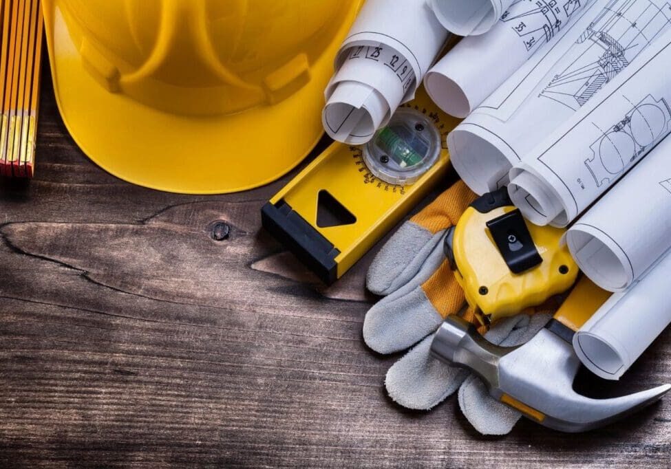 Blueprint rolls and set of construction tools